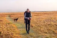 A person hikes outside while wearing the Gregory Women