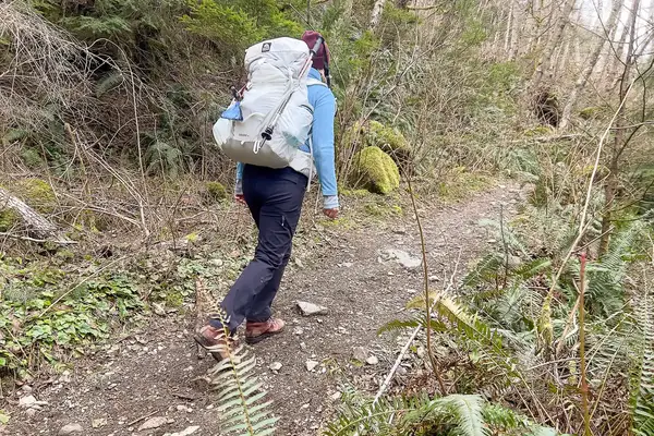 The back of a person hiking while wearing the Granite Gear Crown 3 60L Pack