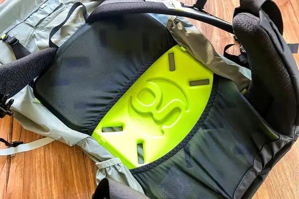 Close-up of the internal back panel and support structure of a Gossamer Gear Mariposa 60 Backpack with a visible neon green component and strap details