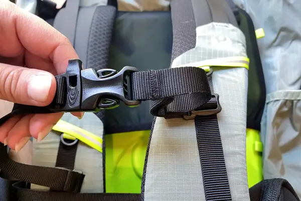 Hands adjusting a fastener on a Gossamer Gear Mariposa 60 Backpack strap