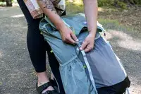 Person adjusting strap on a Gossamer Gear Mariposa 60 Backpack
