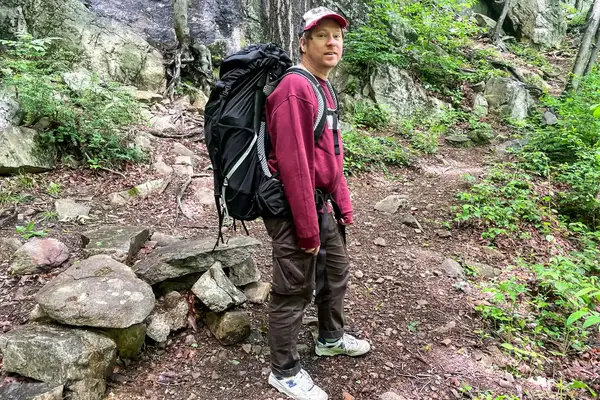 A person wearing a Osprey Atmos AG 65 Men
