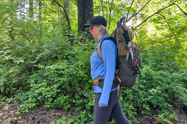 Person hiking with a The North Face Trail Lite 50 Backpack in a forested area