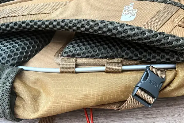 Close-up of the back panels and strap system of a The North Face Trail Lite 50 Backpack, showing mesh padding and a buckle