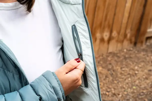 A hand holding the inside pocket of the Outdoor Research Women