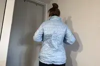 Back view of a woman wearing an L.L.Bean Women’s PrimaLoft Packaway Jacket