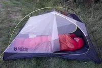 A person sleeps in the Marmot Lost Coast 40° Sleeping Bag inside a tent