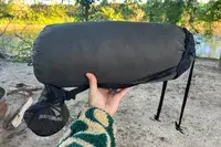 A person holds up the Sea to Summit Spark Down Sleeping Bag inside a storage bag