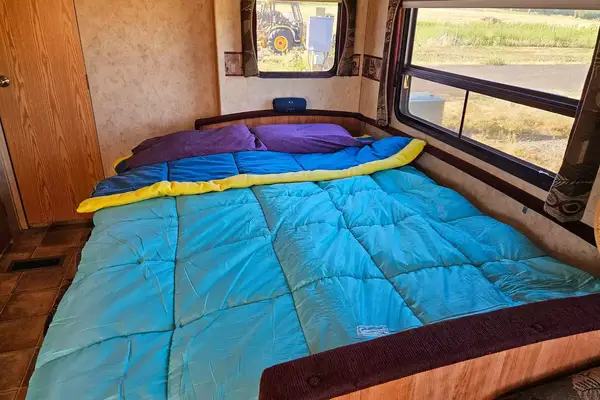 The Coleman Flatlands Fleece 30°F Double Sleeping Bag on a bed