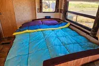 The Coleman Flatlands Fleece 30°F Double Sleeping Bag on a bed