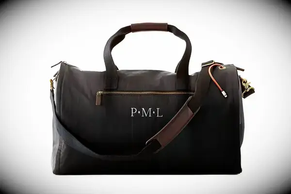 Hand places the Away The Outdoor Convertible Backpack 45L under a seat