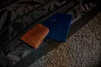 A wallet and a passport sticking out of the The Convertible Weekender