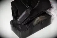 A close up of the The Convertible Weekender with the removable bottom zipped off