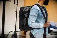A person carrying the Dagne Dover Lagos Convertible Duffle Bag by its handle