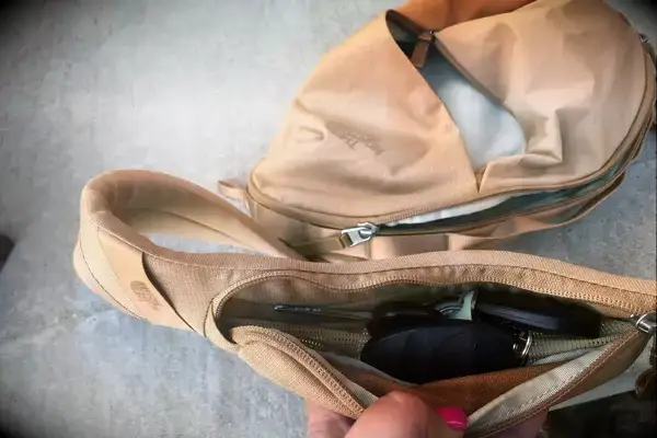 hand holds open part of The North Face Women’s Isabella Sling