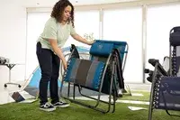 A person lifts the GCI Outdoor Freeform Zero Gravity Lounger