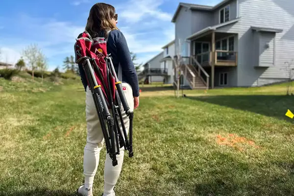 A person carries the GCI Outdoor Kickback Rocker Chair