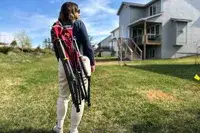 A person carries the GCI Outdoor Kickback Rocker Chair