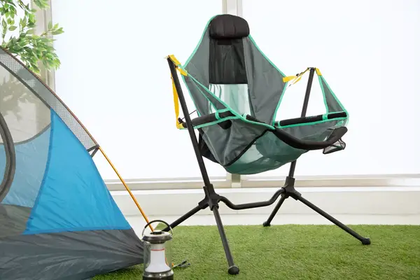 NEMO Moonlite Reclining Camp Chair on grass next to a tent