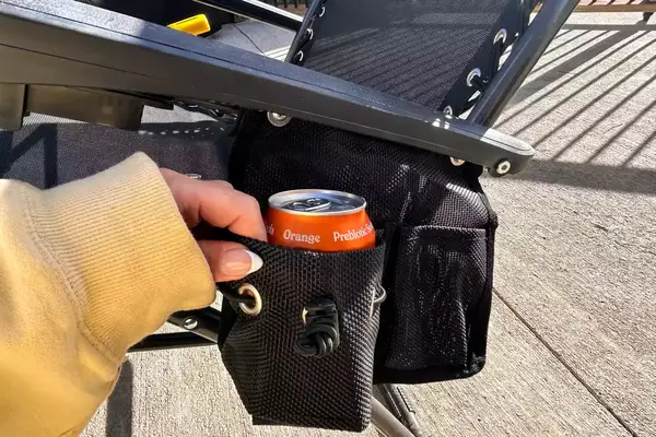 A soda can is placed in the cup rest of the GCI Outdoor Freeform Zero Gravity Lounger