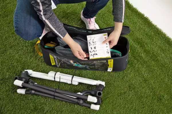 A person taking the NEMO Moonlite Reclining Camp Chair out of the carry bag