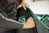 A person assembling the NEMO Moonlite Reclining Camp Chair