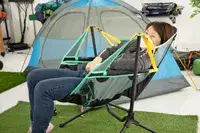 A person sitting in the NEMO Moonlite Reclining Camp Chair