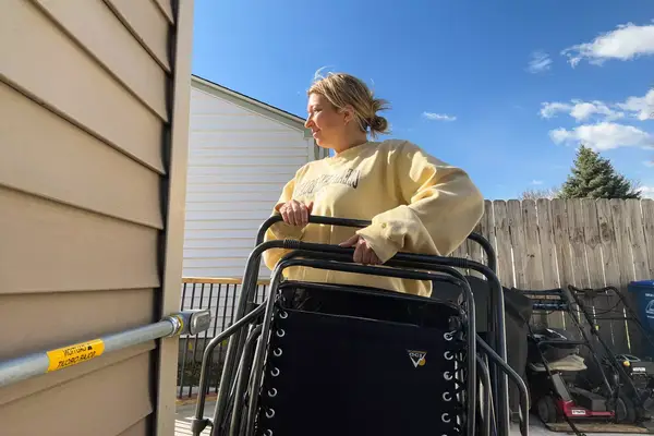 A person lifts the GCI Outdoor Freeform Zero Gravity Lounger