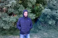 A person standing in front of trees wile wearing the Venture Heat Men