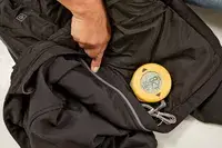 A close-up of a light up button on the Venture Heat Men