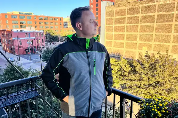 A person standing on a balcony while wearing the Conqueco Men