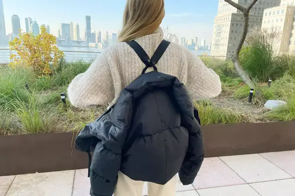 A group of people looking at jackets in a glass box