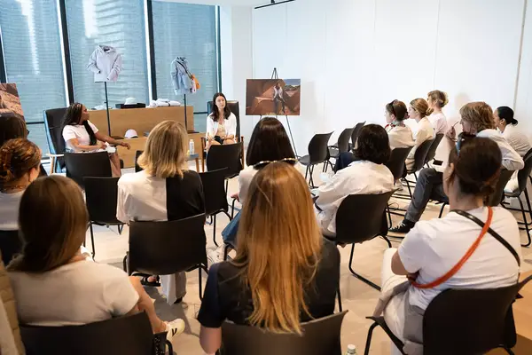 A group of people sitting in chairs discussing Canada Goose