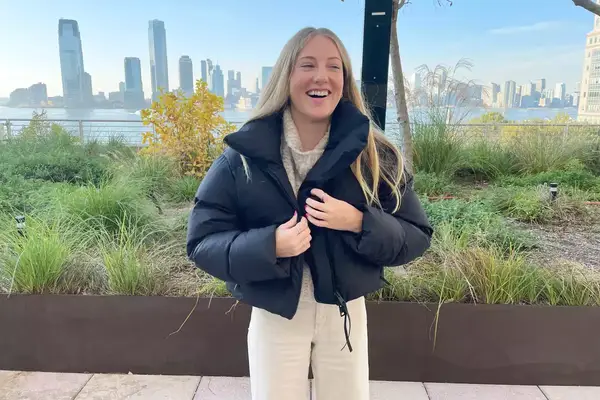 A person wearing the Canada Goose Garnet Cropped Puffer jacket