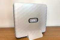 Instax branded device placed on a table appears to be a photo printer or similar equipment