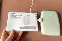 A Fujifilm Instax Mini Link 3 smartphone printer with accompanying user guide