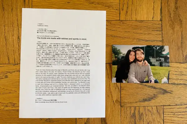 A sheet of text about Mizuhiki with a photo of a smiling couple sitting outdoors on a wooden surface