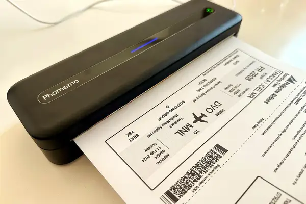 A portable document scanner printing a ticketlike paper