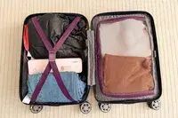 An open suitcase packed with clothing and JADENS Bluetooth Thermal Printer organized with straps and netting