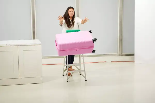 Person pulling a Samsonite Winfield 2 Hardside Luggage With Spinner Wheels through colorful cones