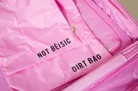 Person pushing Samsonite Winfield 2 Hardside Luggage with Spinner Wheels off a counter