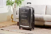 Samsonite Winfield 2 Hardside Luggage With Spinner Wheels displayed in front of a sofa