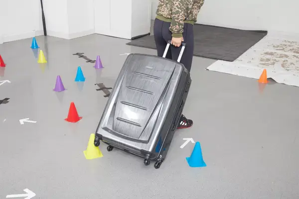 A person places items into the Away The Softside Medium