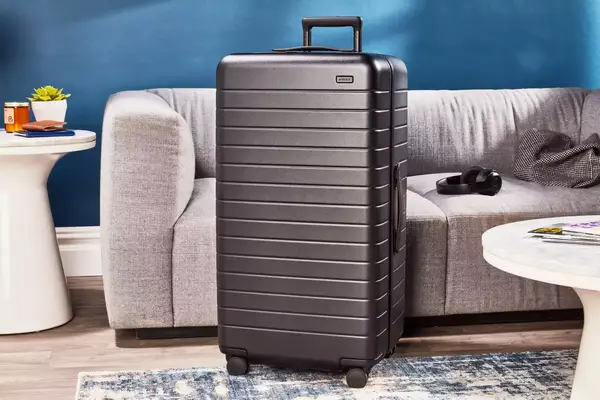 Hand pointing at a small scuff on the Béis The 29-inch Large Check-in Roller