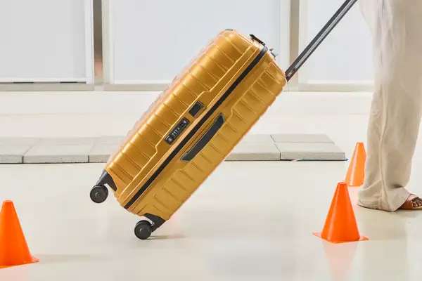 A person wheels the Samsonite Proxis Medium Spinner around cones