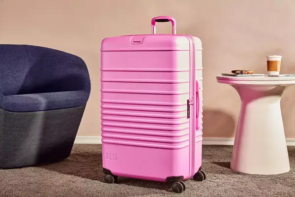 Samsonite Winfield 2 Hardside Luggage With Spinner Wheels being pulled over small rocks
