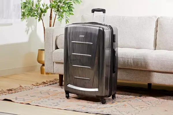 Samsonite Winfield 2 Hardside Luggage With Spinner Wheels displayed in front of a sofa