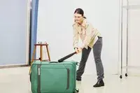 Person hitting the Samsonite Elevation Plus Large Softside Spinner with a bat