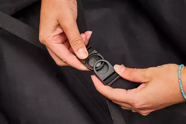 A person snaps the Calpak Hue Trunk Luggage closed