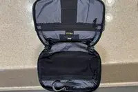The Aer Travel Kit 2 unzipped and opened on a counter